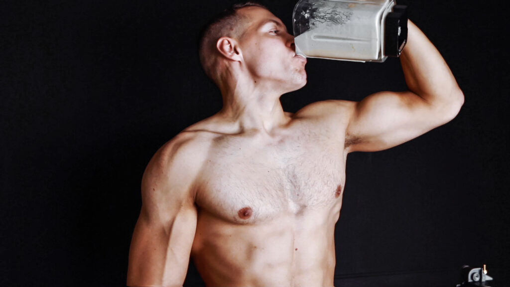 male drinking vegan protein shake from blender